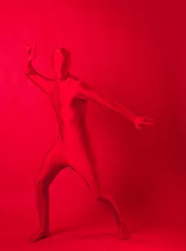 Crazy red man on a red background. figure in a leotard covering the whole body Stock Photos