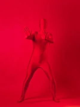 Crazy red man on a red background. figure in a leotard covering the whole body Stock Photos