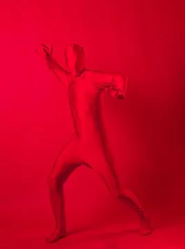 Crazy red man on a red background. figure in a leotard covering the whole body Stock Photos