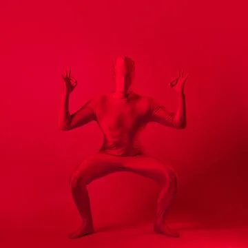 Crazy red man on a red background. figure in a leotard covering the whole body Stock Photos