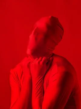 Crazy red man on a red background. figure in a leotard covering the whole body Stock Photos