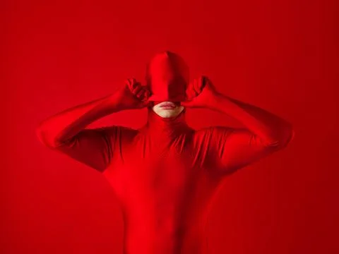 Crazy red man on a red background. figure in a leotard covering the whole body Stock Photos