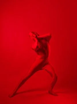 Crazy red man on a red background. figure in a leotard covering the whole body Stock Photos