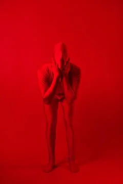 Crazy red man on a red background. figure in a leotard covering the whole body Stock Photos