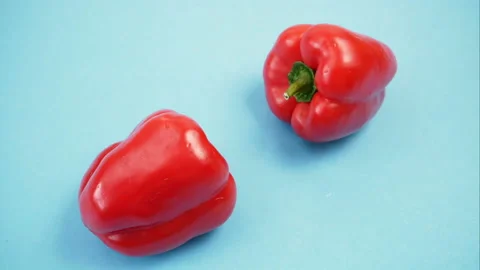 Crazy red sweet pepper dance on blue background, bellpeppers, paprika, stop m 스톡 동영상 144485173