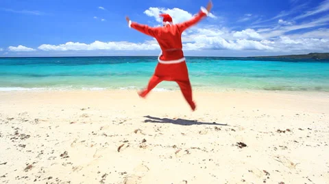 Crazy santa claus jumps on tropical beach Stock Footage