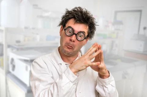 Crazy scientist with glasses thinking about his experiment in laboratory Stock Photos