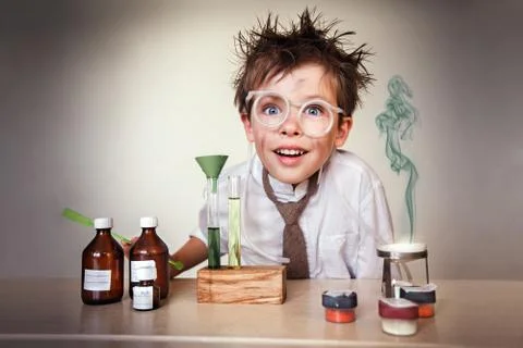 Crazy scientist. Young boy performing experiments Stock Photos