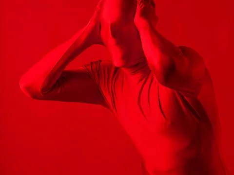 Crazy screaming red man on a red background. figure in a leotard Stock-Fotos