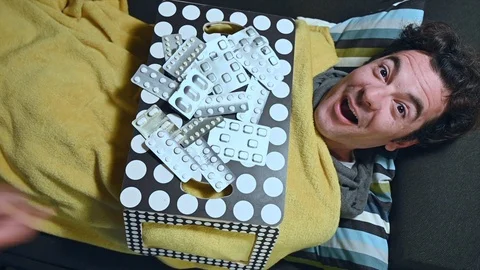 Crazy sick man sleeping on the couch, tray breakfast of drugs happiness Stock Footage 105263587