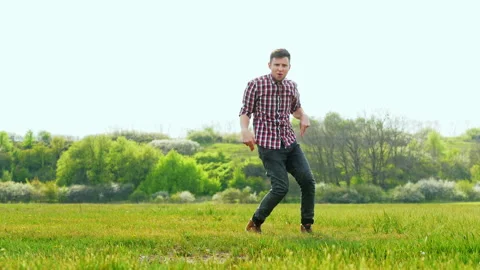 Crazy successful man funny dancing in the green field Stock Footage 137498359