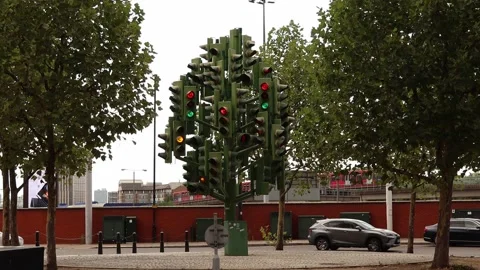 Crazy traffic light tree blinking as cars and train passing in background Stock Footage 206516760