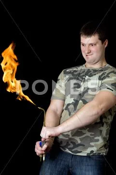 Crazy young man with a gas torch Stock Photos