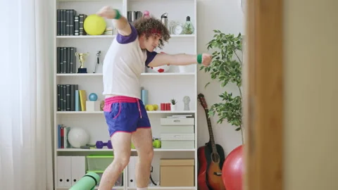 Crazy young man in retro 80s style fitness clothes dancing, awkward movements Stock Footage 217527918