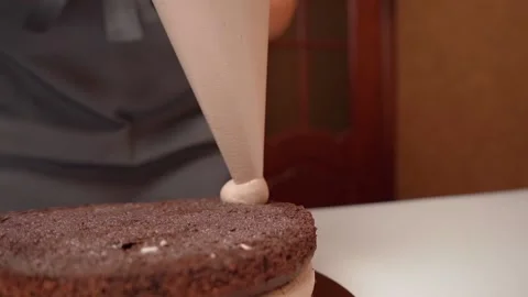 The cream is applied to the sponge cake using a pastry bag Stock Footage 155530706