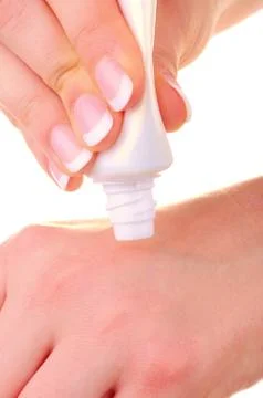 Cream applying on hands Stock Photos