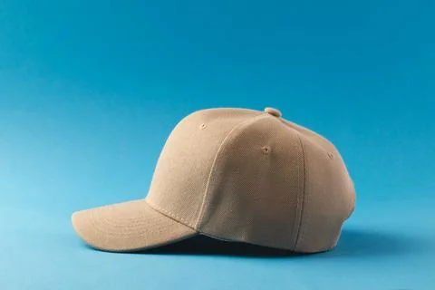 Cream baseball cap and copy space on blue background Stock Illustration