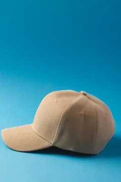 Cream baseball cap and copy space on blue background Stock Illustration