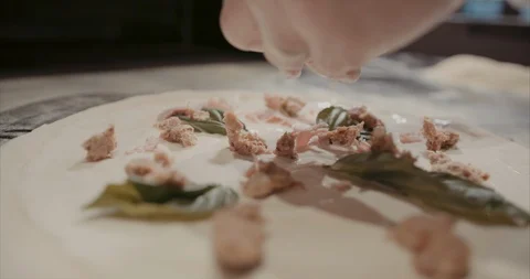 Cream based pizza getting fresh ingredients on it Stock Footage 105300345