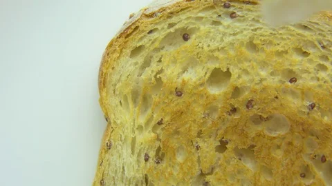 Cream being spread on bread slice Stock Footage 76102845