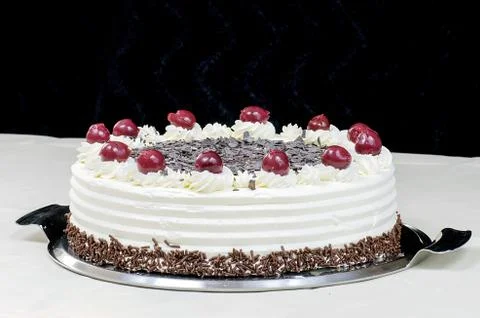 Cream cake with cherries on the table Stock Photos