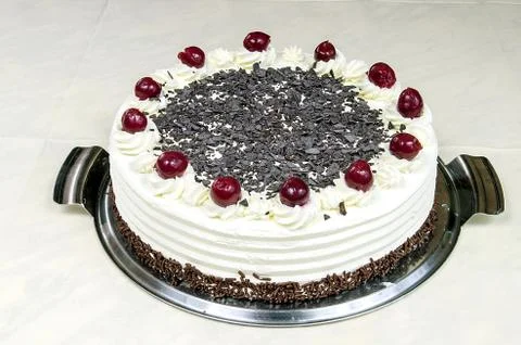 Cream cake with cherries on the table Stock Photos