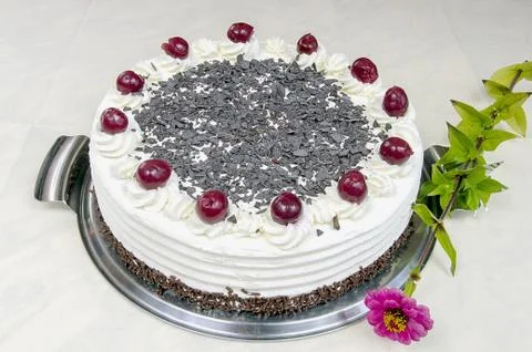 Cream cake with cherries on the table Stock Photos