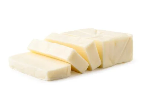 Cream cheese rectangular shape cut into pieces on a white, isolated. Stock Photos