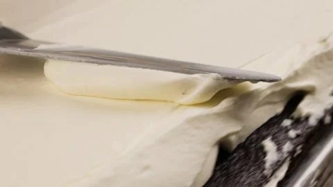 Cream cheese is spread on the cake Stock Footage 260867406