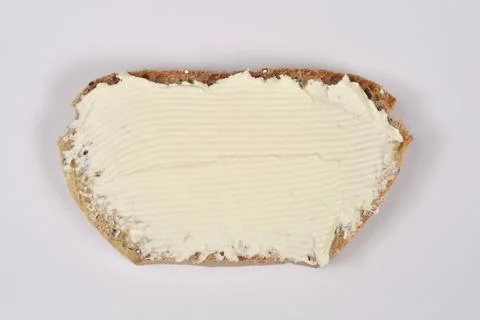 Cream cheese spread on a slice of rustic bread Stock Photos