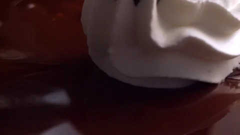  Cream on chocolate surface turning Video stock 81805939