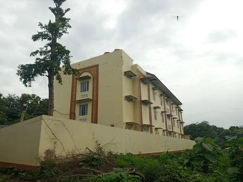 A cream colored multi-storey building seen from behind Stock Photos