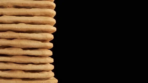 Cream cracker stacked close up isolated against black background stock footag Stock Footage 220454420