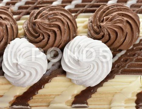 Cream decorations on a cake Stock Photos