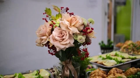 Cream flowers that stand on the table with a buffet Video stock 196920205