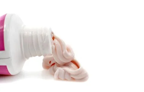 Cream for hands and face squeezed out of a tube on a white background. Skin c Foto stock
