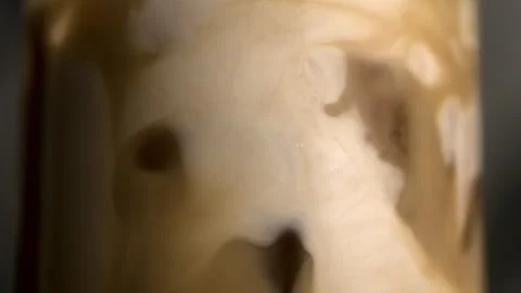 Cream Moving in Iced Coffee in Slow Motion Stock Footage 270408901