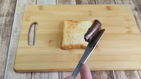 The cream paste was supposed to be spread on bread, but it fell off the knife Stock Footage 199019508