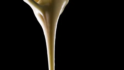 Cream is poured on a black background Stock-Footage 150776193