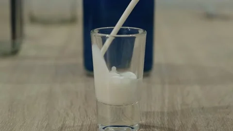 Cream is poured into a stack for making an alcoholic cocktail 動画素材 130325032