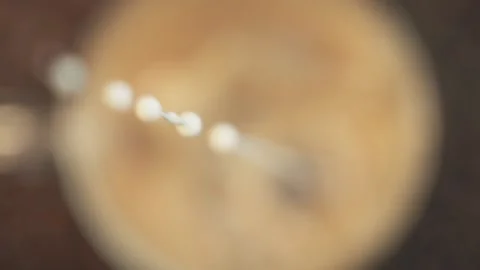 Cream pouring into coffee Stock Footage 146569268