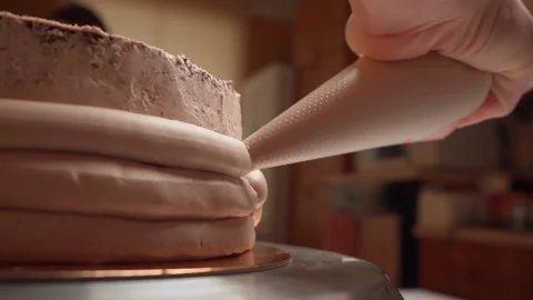 Cream put on board the cake with the help of a confectionery package and a Stock Footage 155530972