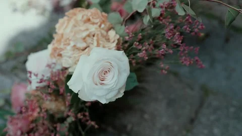 Cream Rose and Peach Hydrangea in a Floral Arrangement on Stone 스톡 동영상 343697423