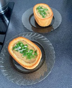 Cream of soup inside a rectangular bread of cauliflower and mushrooms with he Stock Photos