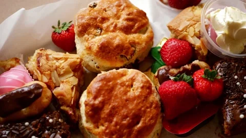 Cream tea with selection of cakes scones and sweets with strawberries Stock Footage 217515690