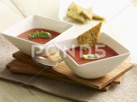 Cream of tomato soup with herb and polenta triangles Stock Photos