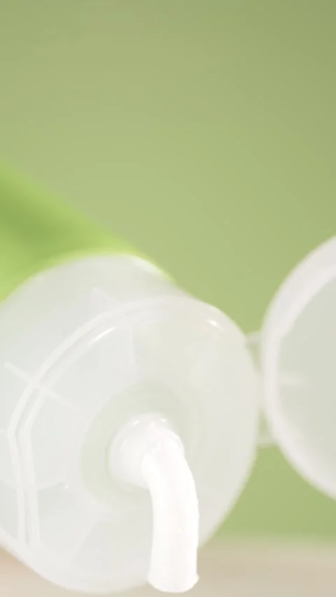 Cream tube with open cap squeezing cosmetic cream. Macro shot Stock Footage 306368288