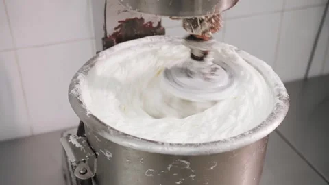 The cream is whipped in an industrial machine Stock Footage 323186980