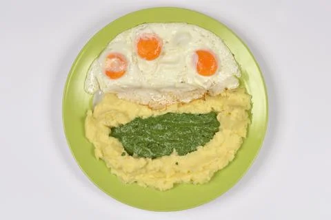 Creamed Spinach with Mashed Potatoes and Fried Eggs Stock Photos