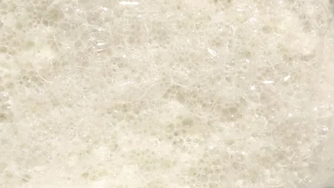 Creamy ASMR soap foam bubbles moving gently on neutral background Stock Footage 311060040
